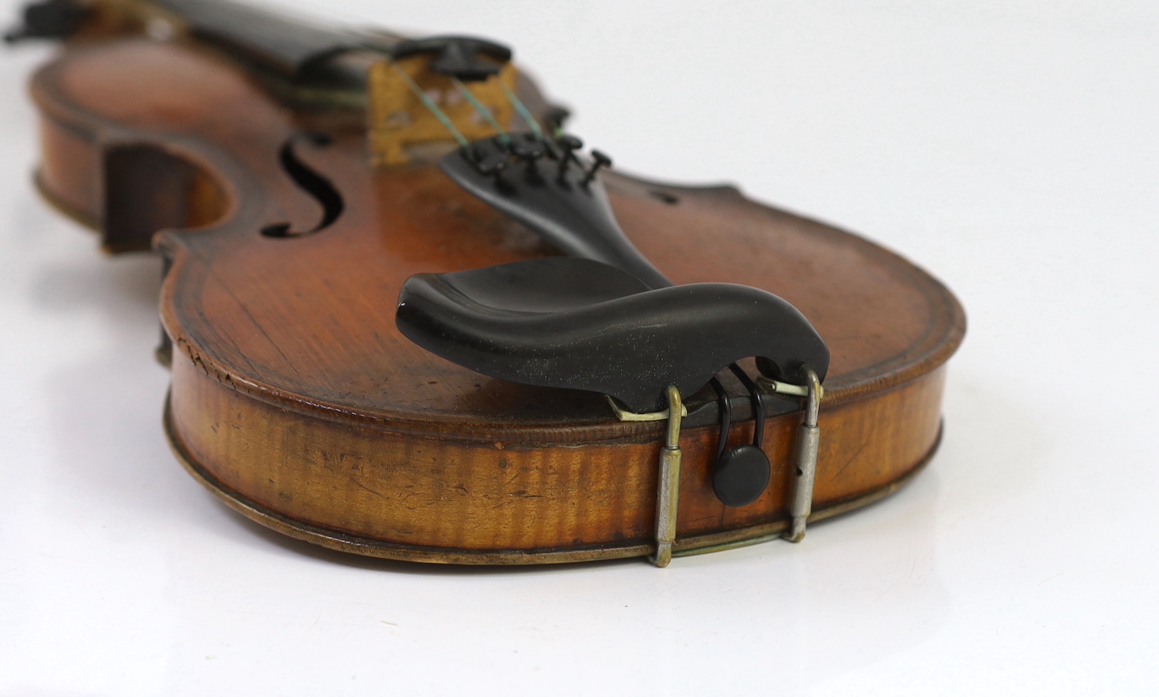 An 18th century violin, labelled ‘New Back by James Carroll, Maker, Manchester 1899’, length of back 36.5cm